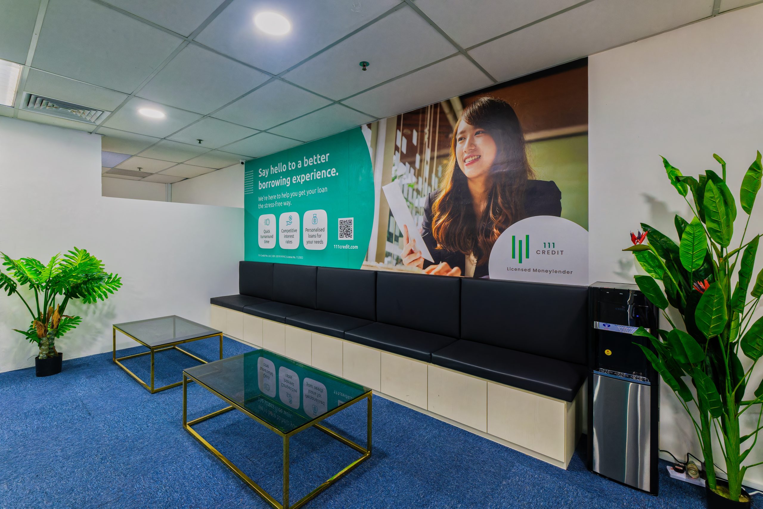 Seats and tables by the side signifying the waiting area for customers in 111 Credit's licensed money lender office